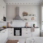 white countertop black backsplash kitchen