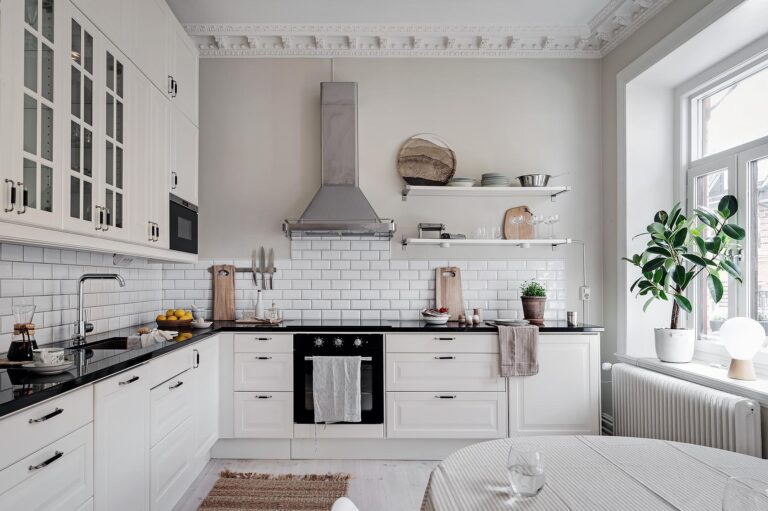 white countertop black backsplash kitchen